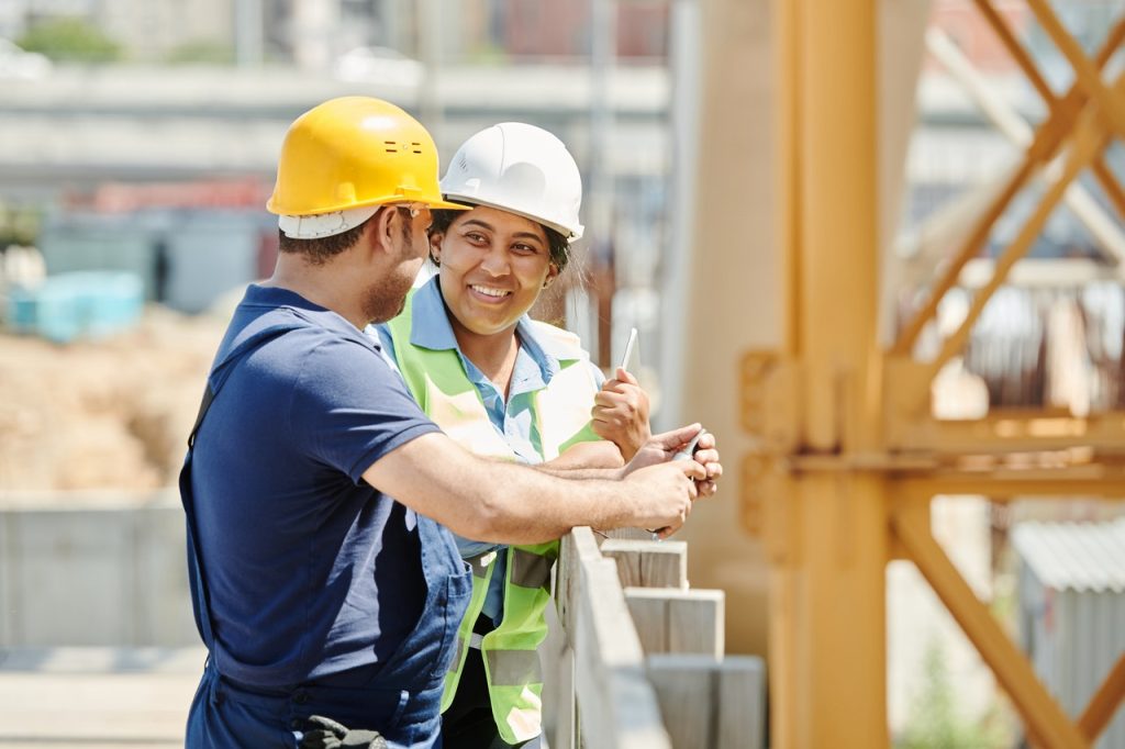 Two construction workers conversing